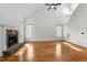Empty living room featuring fireplace, high ceilings, hardwood floors and lots of natural light at 1196 Smith Creek Way, Wake Forest, NC 27587