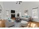 Spacious living room with high ceilings, fireplace, mounted TV, and plenty of natural light at 1196 Smith Creek Way, Wake Forest, NC 27587