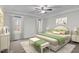Cozy main bedroom featuring tray ceilings, and ample natural lighting from large windows at 1196 Smith Creek Way, Wake Forest, NC 27587