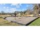 Community playground with swings, slide, and play structure, bordered by grass and wood chips at 1196 Smith Creek Way, Wake Forest, NC 27587