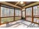 Relax on this screened porch with wood floors, ceiling fan, and view to wooded back yard at 1196 Smith Creek Way, Wake Forest, NC 27587