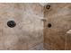 Tiled shower featuring stylish fixtures, stone base, and built-in shelf at 1196 Smith Creek Way, Wake Forest, NC 27587