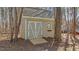 Well-maintained storage shed in backyard with matching double doors and small window for ventilation at 1196 Smith Creek Way, Wake Forest, NC 27587