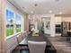 Formal dining room features a long table with gray chairs, accent lighting, and large windows at 1205 Coral Cay Bnd, Wake Forest, NC 27587
