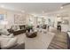 Open-concept living room showcasing stylish furniture, wood floors, and seamless flow to other areas at 1205 Coral Cay Bnd, Wake Forest, NC 27587