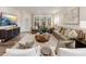 Bright living room with ample seating, large windows, and neutral decor, perfect for relaxation at 1205 Coral Cay Bnd, Wake Forest, NC 27587