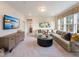 Open living room featuring a large couch, large window, and contemporary decor at 1205 Coral Cay Bnd, Wake Forest, NC 27587