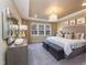 Bright main bedroom featuring a large window, soft carpet, contemporary lighting, and neutral decor at 1205 Coral Cay Bnd, Wake Forest, NC 27587
