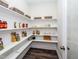 Spacious pantry offers wood floor and ample shelving for storage of household goods at 1205 Coral Cay Bnd, Wake Forest, NC 27587