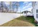 Backyard with a white fence and patio seating, offering a private outdoor space at 121 Black Oak Ct, Clayton, NC 27520
