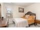 Cozy bedroom with natural light, a quaint bed, and dresser creating a comfortable retreat at 121 Black Oak Ct, Clayton, NC 27520