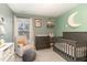 Bedroom with stylish crib, chair, and decor, creating a warm and inviting space at 121 Black Oak Ct, Clayton, NC 27520
