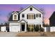 Charming two-story home featuring white siding, black shutters, manicured lawn, and attached garage at 121 Black Oak Ct, Clayton, NC 27520