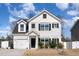 Charming two-story home featuring white siding, black shutters, manicured lawn, and attached garage at 121 Black Oak Ct, Clayton, NC 27520