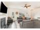 Living room with a gray sectional couch, fireplace and a view of the staircase and front door at 121 Black Oak Ct, Clayton, NC 27520