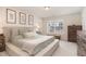 Serene main bedroom with large bed, soft textures, and natural light from the window at 121 Black Oak Ct, Clayton, NC 27520