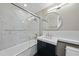 Modern bathroom featuring marble tile walls, shower with sliding glass doors, and updated vanity at 122 N Harrington St # 1025, Raleigh, NC 27603