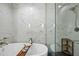 Relaxing bathroom featuring a soaking tub, a glass-enclosed shower, and marble tile surround at 122 N Harrington St # 1025, Raleigh, NC 27603