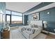 Bright bedroom with a large window offering city views, stylish decor, and hardwood floors at 122 N Harrington St # 1025, Raleigh, NC 27603