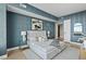 Well-lit bedroom showcasing designer wallpaper, elegant furnishings, and a light-colored area rug at 122 N Harrington St # 1025, Raleigh, NC 27603