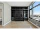 Spacious bedroom with a built-in black bookshelf, hardwood floors, and ample natural light from a large window at 122 N Harrington St # 1025, Raleigh, NC 27603