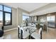Modern dining area with a glass table and an open view into the kitchen for easy and elegant entertaining at 122 N Harrington St # 1025, Raleigh, NC 27603