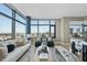 Open concept living room showcasing large windows with cityscape views and contemporary furniture at 122 N Harrington St # 1025, Raleigh, NC 27603