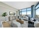 Bright living room features a large window with expansive city views and modern decor at 122 N Harrington St # 1025, Raleigh, NC 27603
