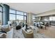 Stylish living room with floor-to-ceiling windows, an open floor plan, and a modern kitchen at 122 N Harrington St # 1025, Raleigh, NC 27603