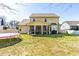 Exterior view showcasing the home's backyard with a covered patio at 131 Tracker Ct, Garner, NC 27529