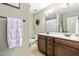 Bathroom featuring double sinks, wood cabinets, and a framed mirror with bright lighting at 131 Tracker Ct, Garner, NC 27529