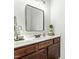 Bathroom featuring a dark wood vanity, white countertop, and modern mirror and lighting at 131 Tracker Ct, Garner, NC 27529