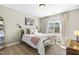 Cozy bedroom features a decorative iron bed frame, neutral walls, and a window with pretty curtains at 131 Tracker Ct, Garner, NC 27529