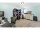 Bedroom with a desk and chair with a bookshelf and dresser against a blue painted wall at 131 Tracker Ct, Garner, NC 27529