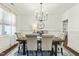 Elegant dining room featuring a modern chandelier, a stylish rug, and seating for six for memorable meals at 131 Tracker Ct, Garner, NC 27529