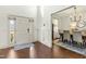 Bright foyer with hardwood floors, wainscoting, and an adjacent dining area offering a stylish entry at 131 Tracker Ct, Garner, NC 27529