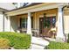 Inviting front porch with a decorative wreath, rocking chair, and lantern, creating a warm welcome at 131 Tracker Ct, Garner, NC 27529