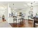 Open concept kitchen with stainless steel appliances, granite countertops, island, and a dining area at 131 Tracker Ct, Garner, NC 27529