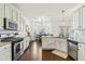 Bright, open kitchen with stainless steel appliances, granite countertops, subway tile backsplash, and a breakfast bar at 131 Tracker Ct, Garner, NC 27529