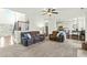 Open-concept living room featuring neutral colors, comfortable seating, and seamless flow to dining area at 131 Tracker Ct, Garner, NC 27529