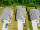 Aerial view of homes with well-manicured lawns and long driveways at 1401 Wrenn Rd, Durham, NC 27703