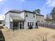 The rear of the house shows a screened in porch, patio, and dormant lawn surrounded by a wood fence at 1401 Wrenn Rd, Durham, NC 27703
