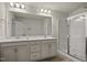 Modern bathroom featuring a double sink vanity, walk-in shower, and ample counter space at 1401 Wrenn Rd, Durham, NC 27703
