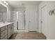 Neutral bathroom featuring a walk-in shower, single sink vanity, and tiled floors at 1401 Wrenn Rd, Durham, NC 27703