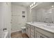 Well-lit bathroom featuring a double vanity, tiled floors, and shower-tub combo at 1401 Wrenn Rd, Durham, NC 27703