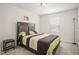 Cozy bedroom with natural light, carpet, and a modern accent wall hanging at 1401 Wrenn Rd, Durham, NC 27703