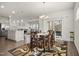 Inviting dining area with stylish rug, wood table, and view to the outdoor patio at 1401 Wrenn Rd, Durham, NC 27703