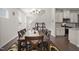 Charming dining room featuring a long wooden table, seating for six, and a kitchen view at 1401 Wrenn Rd, Durham, NC 27703