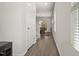 Hallway featuring wood-look flooring and a view into the dining area with natural light at 1401 Wrenn Rd, Durham, NC 27703