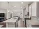 Kitchen with granite island, stainless appliances, and wood floors, open to dining area at 1401 Wrenn Rd, Durham, NC 27703